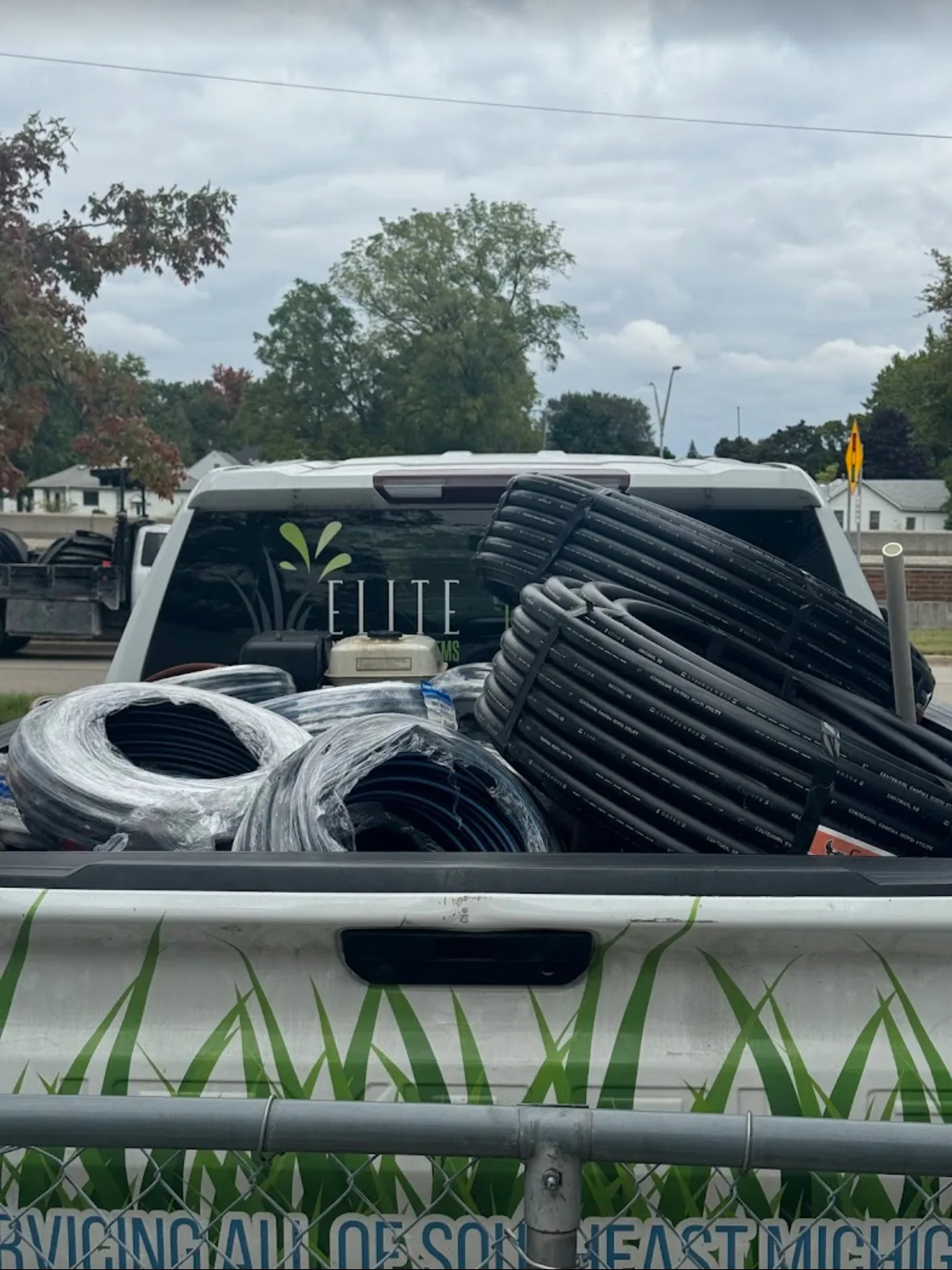 Elite Sprinkler Systems service truck bed loaded with irrigation supplies in Michigan