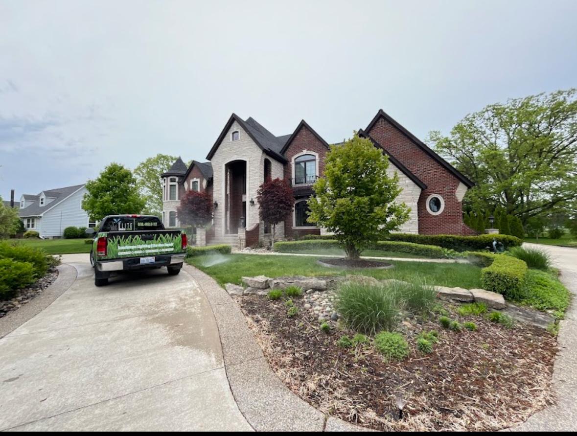 Elite Sprinkler Systems truck at a Tudor home irrigation job in Metro Detroit, Michigan.